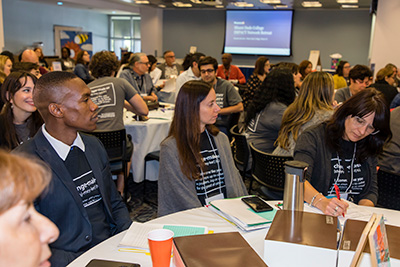 Students and faculty in a conference room