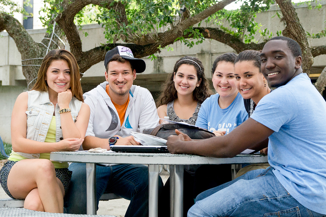 Students sitting at a table outdoors
